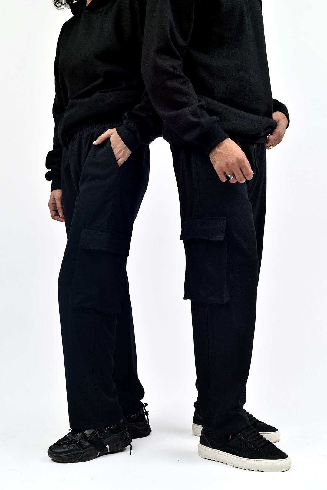 Male and female models wearing unisex cargo pants – men’s trousers available online in modern streetwear style
